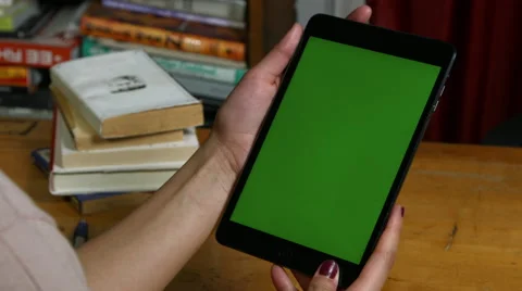 Millenial Girl using a green screen ipad Stock Footage 59777357
