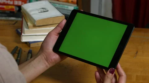 Millenial Girl using a green screen ipad Stock Footage 59777973