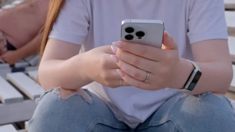 Millenial girl using smartphone on beach sea on sunset. Always connected Stock Footage 244590548