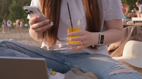 Millenial girl using smartphone on beach sea on sunset. Always connected Stock Footage 245408202