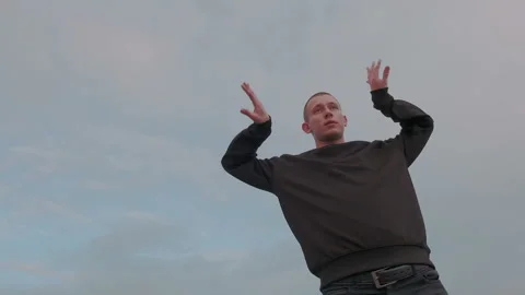 Millenial high-minded man practice original street dance outdoor on the sky Stock Footage 105463849