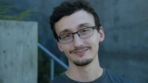 Millenial looks into camera with a half smile. Stock Footage 93577285