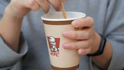 Millenial mixing KFC tea Stock Footage 119939425