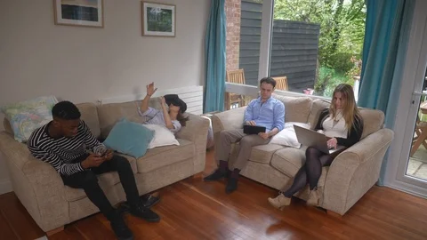 Millenials at home working tablet VR headset laptop all together remote  Stock Footage 89921120