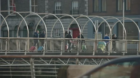Millenium bridge dublin with light traffic and people crossing Stock Footage 170669752