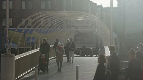 Millenium bridge dublin with light traffic and people crossing Stock Footage 170669774