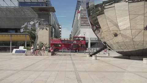 Millenium square bristol slow mo sunny red bus Stock Footage 69772929