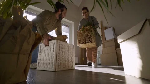 Millennial couple carries boxes in new house Video stock 145313063