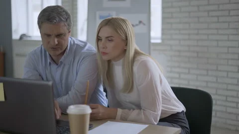 Millennial coworkers comparing notes using tablets. Young corporate Stock Footage 112679795