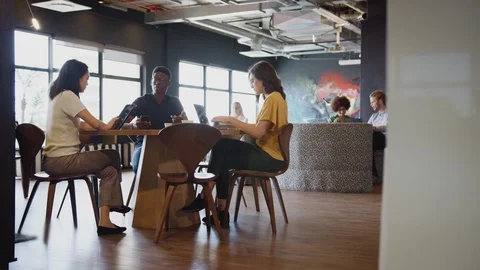 Millennial creative business colleagues working and socialising in their office Stock Footage 111928704