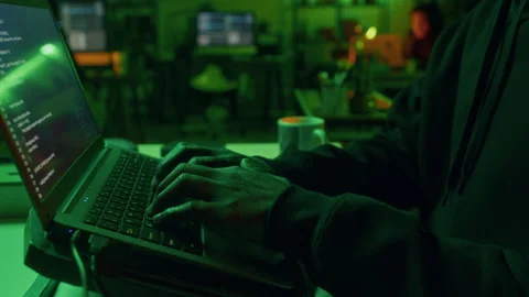 Millennial Cybercriminal Coding on Laptop Committing Malicious Activities Stock Footage 299275330