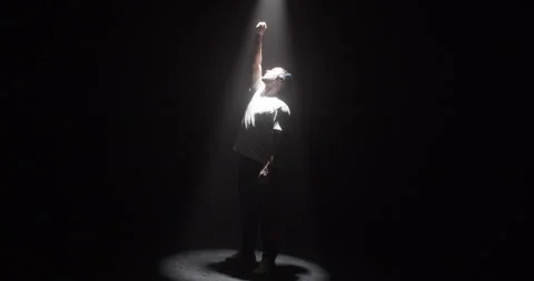 Millennial dancer in spotlight in dark Stock Footage 244523734