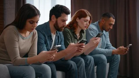 Millennial diverse four friends overusing mobile phones addicted gadgets at home 写真素材