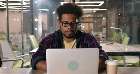 Millennial freelancer focusing on task working on laptop in modern office. Data Stock Footage 163549784