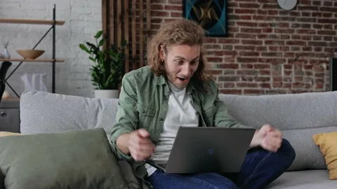 Millennial freelancer reading letter in his laptope with good news celebrate Stock Footage 166322730