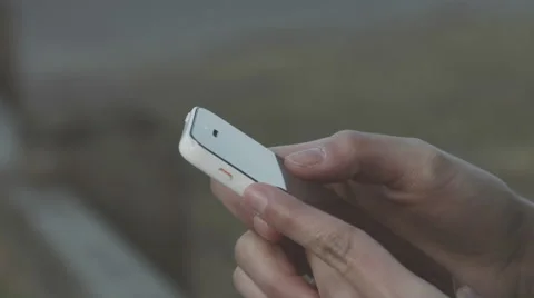 Millennial Girl casually using her smartphone outside Stock Footage 59840203