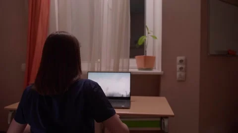 Millennial girl getting ready to work with open laptop at home against night Stock Footage 130801481