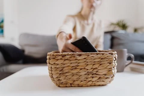 Millennial girl at home refuse using phone and reading a book. Social media Stock Photos