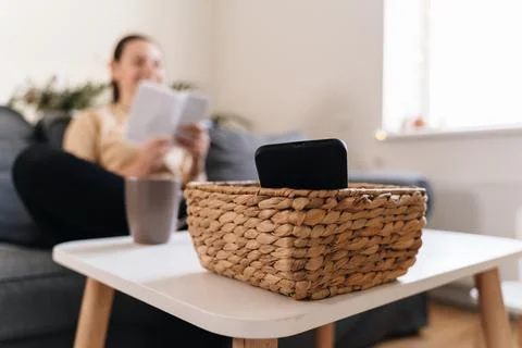 Millennial girl at home refuse using phone and reading a book. Social media Stock Photos