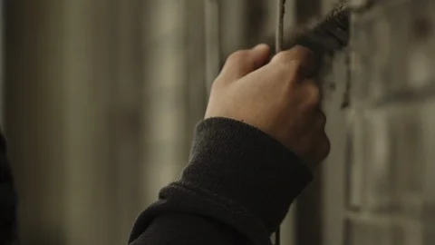 Millennial grasps at wall of a broken down burnt out abandoned building Stock Footage 88051503