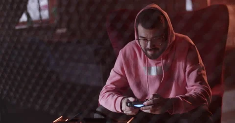 Millennial guy playing videogame in cafe Stock Footage 229484318