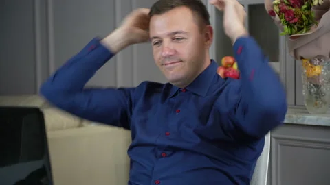 Millennial guy relaxing at kitchen with notebook on table, he is sitting with Stock Footage 169412696