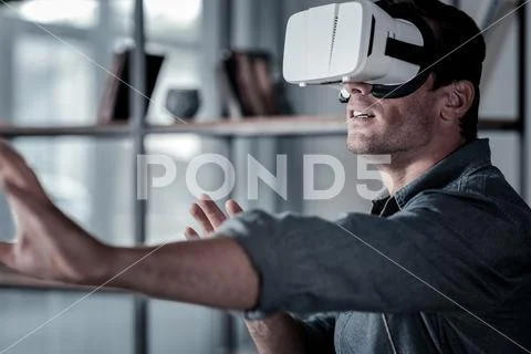 Millennial guy wearing virtual reality goggles Stock Photos