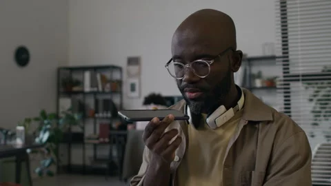 Millennial Male Programmer Talking on Mobile Phone while Working on Laptop Stock Footage 299244101