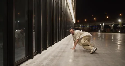 Millennial man break dancing on street Stock Footage 244474810