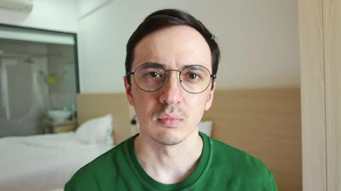 Millennial man with glasses smiling and showing emotions Video stock 337367147