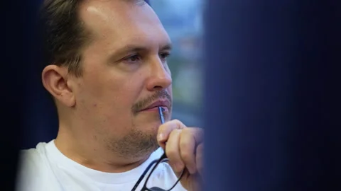 Millennial man looks out window of moving commuter train and bites handle of his Stock Footage 169745666