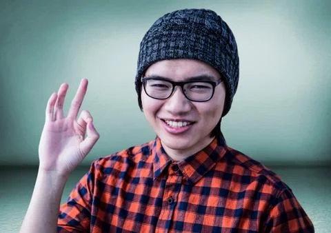 Millennial man making ok sign in green room 스톡 사진