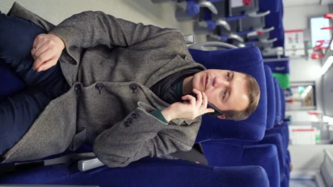 Millennial man making phone call in subway train. Happy guy commuting to work Stock Footage 168243359