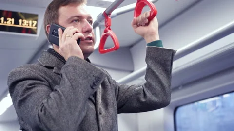 Millennial man making phone call in subway train. guy commuting to work on train Stock Footage 169745825