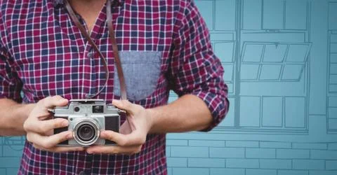 Millennial man mid section with camera against blue hand drawn windows 스톡 사진