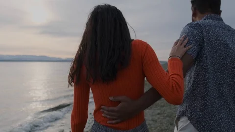 Millennial middle eastern couple walking on beach at blue hour Stock Footage 111976896