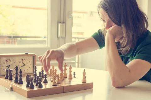Millennial playing a strategy game of chess. Stock Photos