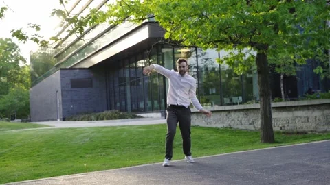 Millennial professional businessman Actively Dancing close to business center.  Stock Footage 244244989