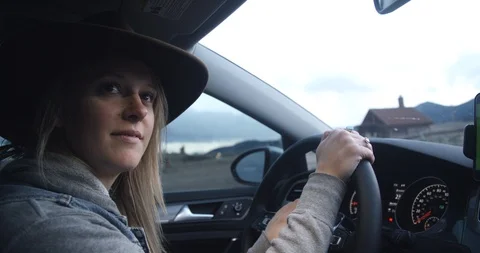 Millennial ride share driver in hat accepts trip on phone app with car mount Stock Footage 88337259