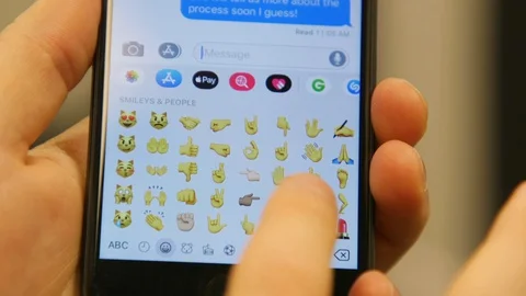 Millennial Scrolling on Message App and Send the Waving Emoji on Smartphone 動画素材 127774097