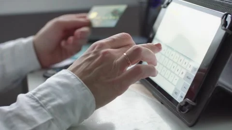 Millennial shopper paying on website ordering delivery mobile phone tablet ta Stock Footage 265929205