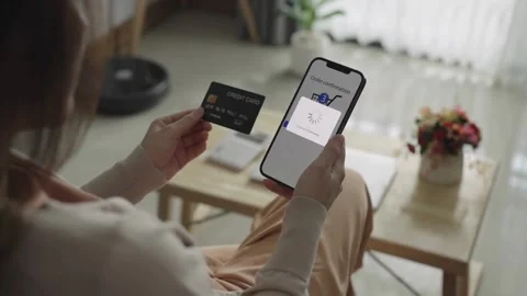 Millennial shopper paying on website ordering delivery mobile phone smartphon Stock Footage 265930651