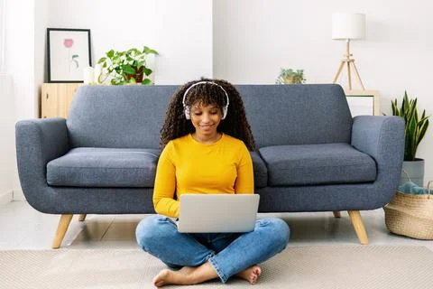 Millennial student adult woman using laptop computer at home Stock Photos