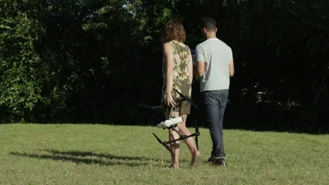 Millennial Tech Partners Carry A Drone Through A Park In Sillicone Valley In Видео 82595328
