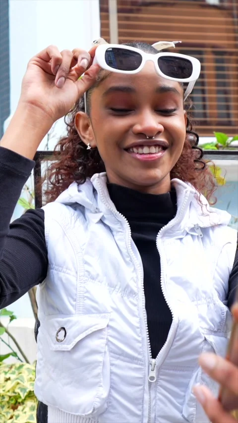 Millennial in urban clothes taking selfie outside a colorful house Stock Footage 302166869