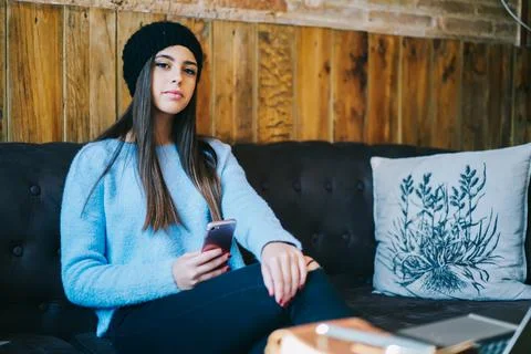 Millennial user with mobile phone posing indoors Stock Photos