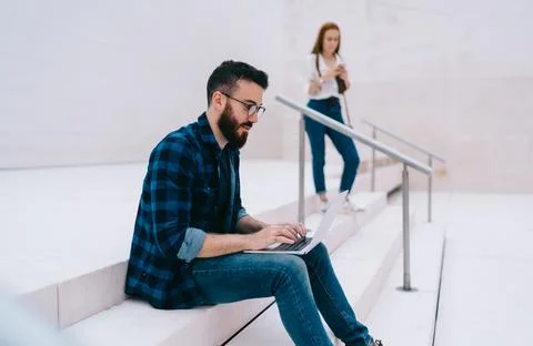 Millennial user working remotely via netbook reading received email with Stock Photos