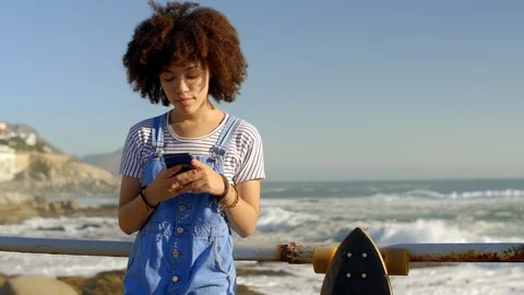 Millennial using her phone texting outdoors Stock Footage 118603930