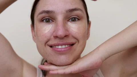 Millennial woman doing face procedures,applying under eye patches Stock-Footage 242990237