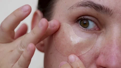 Millennial woman doing face procedures,applying under eye patches Stock-Footage 242990244